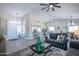 Open-concept living area boasts a modern chandelier, neutral color palette, and beautiful flooring at 3070 N 148Th Dr, Goodyear, AZ 85395