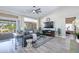 Spacious living room with sliding glass doors, vaulted ceiling with fan, and stylish decor at 3070 N 148Th Dr, Goodyear, AZ 85395