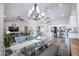 Open concept dining and living spaces featuring light wood floors, modern chandelier, and view of kitchen at 3070 N 148Th Dr, Goodyear, AZ 85395