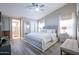 Spacious main bedroom with a neutral color palette, ceiling fan, ensuite bathroom and walk-in closet at 3070 N 148Th Dr, Goodyear, AZ 85395