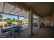 Inviting covered patio area offering a relaxing outdoor space with views of landscaped backyard at 3070 N 148Th Dr, Goodyear, AZ 85395