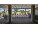 Covered patio area, offering shade, privacy, and outdoor seating with a view of well-manicured landscaping at 3070 N 148Th Dr, Goodyear, AZ 85395