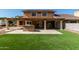 Backyard with a large covered patio and green grass at 3203 E Ellis St, Mesa, AZ 85213
