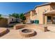 Backyard with fire pit and a trailer and AC units in the background at 3203 E Ellis St, Mesa, AZ 85213