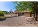 View of the backyard, with gravel ground and a white picket fence surrounding the area at 3203 E Ellis St, Mesa, AZ 85213