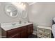 Bathroom featuring a double vanity with matching round mirrors at 3203 E Ellis St, Mesa, AZ 85213