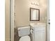 Small bathroom with toilet, small white vanity and shelving to the left at 3203 E Ellis St, Mesa, AZ 85213