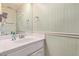 Charming half bathroom with a sink, mirror, and beadboard walls at 3203 E Ellis St, Mesa, AZ 85213