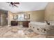 Spacious bathroom with dual vanities, a soaking tub, a shower, and tile flooring at 3203 E Ellis St, Mesa, AZ 85213