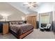 Main bedroom with two-toned walls, ceiling fan, and dark wood sliding door closet at 3203 E Ellis St, Mesa, AZ 85213