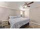 Comfortable bedroom featuring a ceiling fan and striped bedding at 3203 E Ellis St, Mesa, AZ 85213