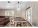 Charming dining room with a chandelier, table set for six, and French doors at 3203 E Ellis St, Mesa, AZ 85213