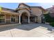 Welcoming home entrance with a covered porch, pillars, and ample parking space at 3203 E Ellis St, Mesa, AZ 85213