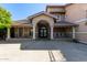 Attractive home facade featuring a covered entrance, supporting columns, and ample parking at 3203 E Ellis St, Mesa, AZ 85213