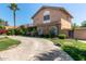 Stately home with a circular driveway, stone accents, and beautifully maintained landscaping at 3203 E Ellis St, Mesa, AZ 85213