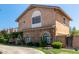 Elegant two-story home showcasing stone details, a private balcony, and lush, green surroundings at 3203 E Ellis St, Mesa, AZ 85213