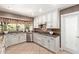 Well-lit kitchen showcases stainless steel appliances and custom white cabinetry at 3203 E Ellis St, Mesa, AZ 85213