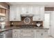 Custom kitchen with stainless appliances, gas cooktop, and mosaic backsplash at 3203 E Ellis St, Mesa, AZ 85213