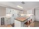 Well-lit kitchen featuring a functional island, white cabinetry, and modern appliances at 3203 E Ellis St, Mesa, AZ 85213