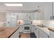 Updated kitchen featuring white cabinetry, granite countertops, and modern appliances at 3203 E Ellis St, Mesa, AZ 85213