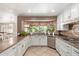 Bright kitchen offering stainless appliances, granite counters, and a breakfast bar at 3203 E Ellis St, Mesa, AZ 85213