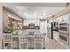 Elegant kitchen featuring stainless appliances, granite countertops, and white cabinets at 3203 E Ellis St, Mesa, AZ 85213