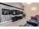 Home theater room featuring a popcorn machine, three flat screen tv's and comfortable seating at 3203 E Ellis St, Mesa, AZ 85213