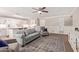 Cozy living room featuring a ceiling fan, plush seating, and seamless flow to the kitchen at 3203 E Ellis St, Mesa, AZ 85213