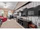 Spacious living room featuring a large television, ceiling fan, and recessed lighting at 3203 E Ellis St, Mesa, AZ 85213