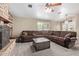 Comfortable living room with a decorative ceiling fan, fireplace, and neutral carpet at 3203 E Ellis St, Mesa, AZ 85213