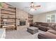 Comfortable living room boasts a stone fireplace, ceiling fan, and wooden accents at 3203 E Ellis St, Mesa, AZ 85213