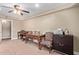 Home office with neutral walls, ceiling fan, and antique writing desks with chairs at 3203 E Ellis St, Mesa, AZ 85213