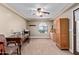 Office space with desk, tray ceiling, arched window, ceiling fan, and wood armoire at 3203 E Ellis St, Mesa, AZ 85213