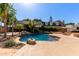 Beautiful pool with rock waterfalls and lush landscaping that create a relaxing backyard oasis at 3203 E Ellis St, Mesa, AZ 85213