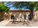 View of a backyard shed with an air conditioner and two windows at 3203 E Ellis St, Mesa, AZ 85213