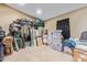 A messy storage room filled with boxes, equipment, and hanging clothes at 3203 E Ellis St, Mesa, AZ 85213