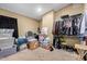 A messy storage room filled with many boxes and hanging clothes at 3203 E Ellis St, Mesa, AZ 85213