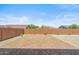 Spacious backyard with brick privacy wall and low-maintenance desert landscaping at 3366 E Constance Way, Phoenix, AZ 85042