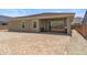 Rear exterior showcasing patio, stucco, sliding glass doors and desert landscaping at 3366 E Constance Way, Phoenix, AZ 85042