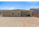 Rear exterior view showing stucco, desert landscaping, patio and windows at 3366 E Constance Way, Phoenix, AZ 85042