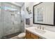 Modern bathroom features a glass enclosed shower with stylish tile and updated vanity at 3366 E Constance Way, Phoenix, AZ 85042