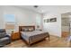Bedroom featuring wood-look tile flooring, two shuttered windows and cozy gray bed at 3366 E Constance Way, Phoenix, AZ 85042