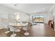 Stylish dining area with modern white chairs, a sleek table, a contemporary light fixture and backyard access at 3366 E Constance Way, Phoenix, AZ 85042