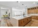 Open concept kitchen with center island, view into dining and living areas, and stainless-steel dishwasher at 3366 E Constance Way, Phoenix, AZ 85042