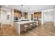 Bright, spacious kitchen with an expansive island, wooden cabinetry, and modern stainless-steel appliances at 3366 E Constance Way, Phoenix, AZ 85042