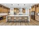 Bright, open kitchen features an oversized island, stainless steel appliances, and stylish pendant lighting at 3366 E Constance Way, Phoenix, AZ 85042