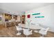 Open-concept kitchen and dining area featuring modern design, an island, and sleek white chairs at 3366 E Constance Way, Phoenix, AZ 85042