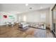 Open living space with a modern white sofa, designer furniture, a stylish rug and dining area at 3366 E Constance Way, Phoenix, AZ 85042