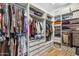Organized walk-in closet featuring custom shelving, hanging racks, and ample storage space at 3366 E Constance Way, Phoenix, AZ 85042