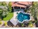 Aerial view of home with swimming pool, hot tub, patio, and green lawns at 3522 E Cherokee St, Phoenix, AZ 85044